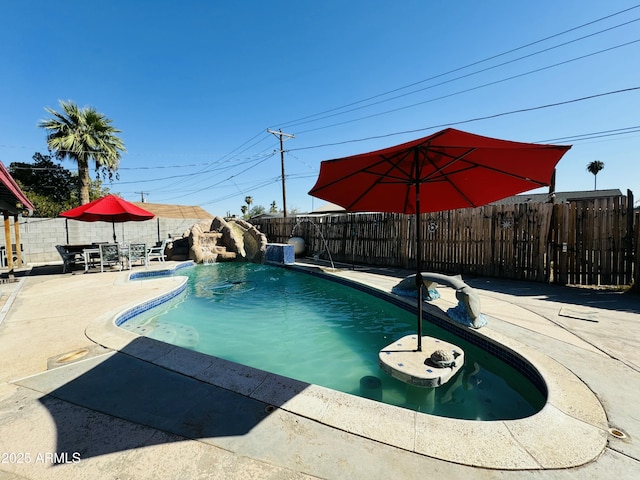 view of pool featuring pool water feature and a patio