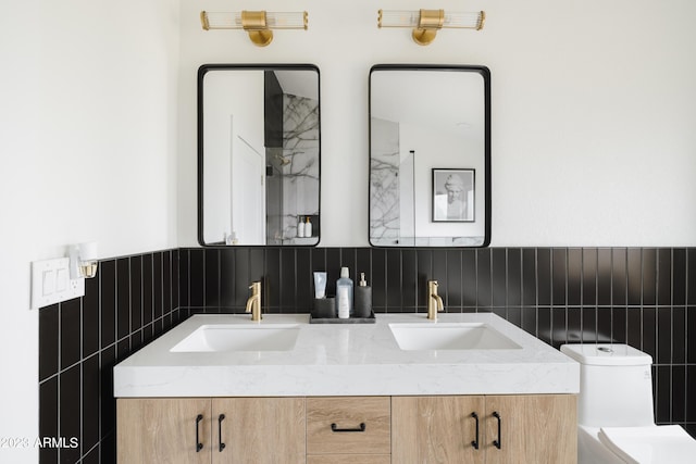 bathroom featuring tile walls, vanity, and toilet