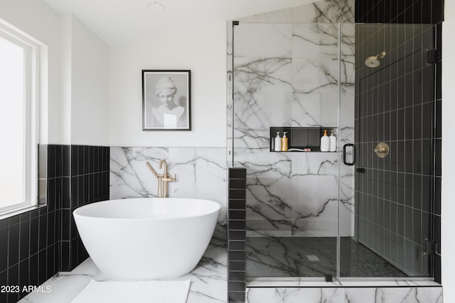 bathroom featuring separate shower and tub