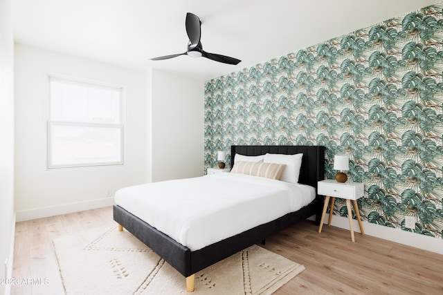 bedroom with ceiling fan and light wood-type flooring