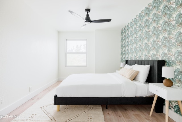 bedroom with ceiling fan and light wood-type flooring