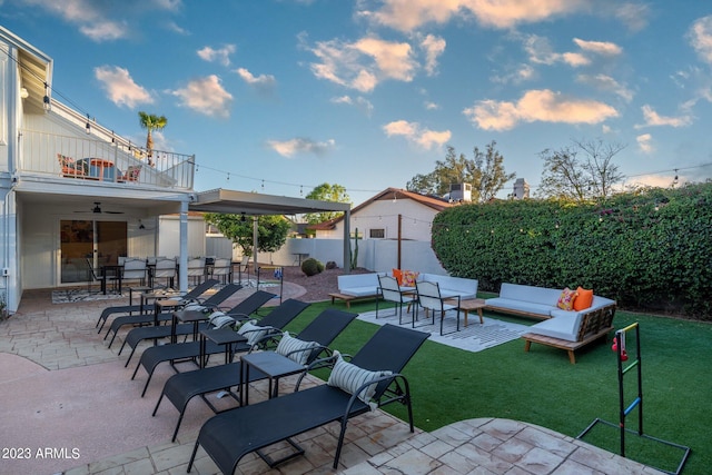 view of patio with ceiling fan, an outdoor hangout area, and a balcony