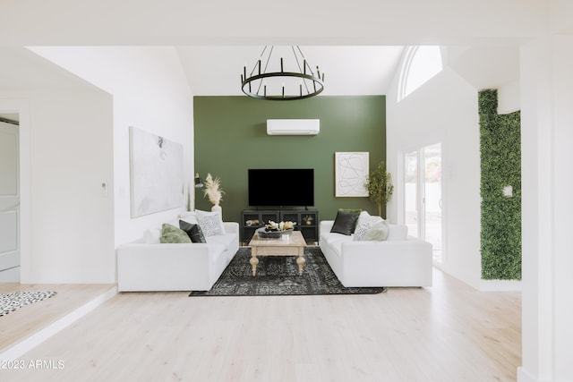 living room with hardwood / wood-style flooring, a chandelier, and an AC wall unit