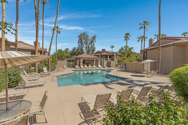 community pool featuring a patio and fence