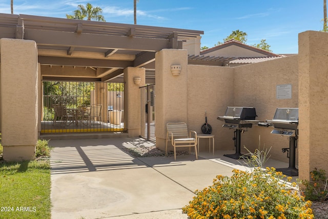 view of patio with area for grilling and fence