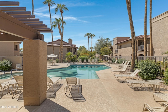 pool featuring fence and a patio area