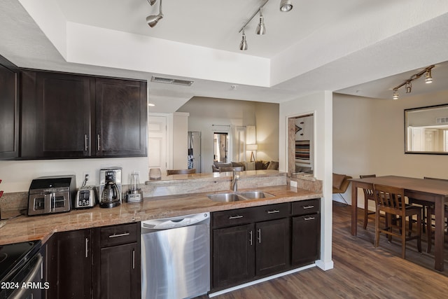 kitchen with dishwasher, light stone counters, sink, and dark hardwood / wood-style floors