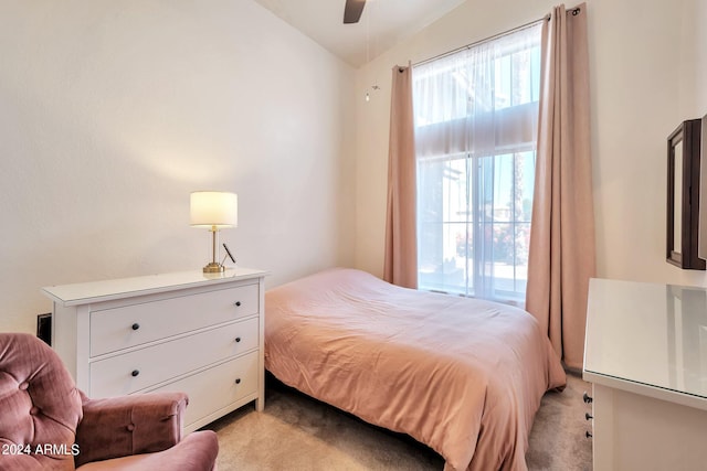 bedroom with vaulted ceiling, ceiling fan, and light colored carpet