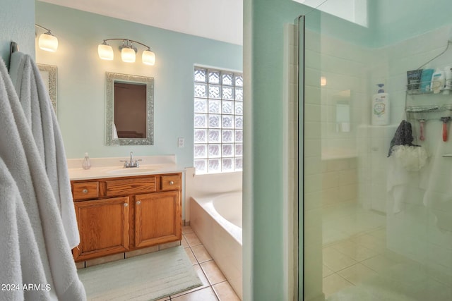 bathroom featuring independent shower and bath, tile patterned flooring, and vanity