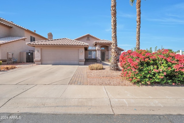 mediterranean / spanish-style home featuring a garage