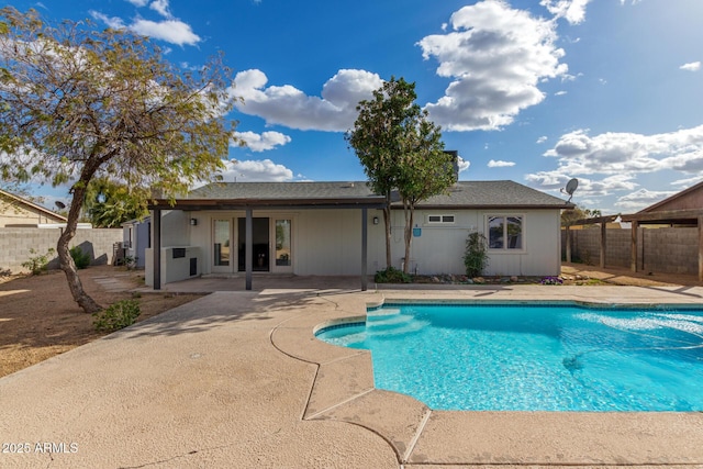 view of swimming pool featuring a fenced backyard, a fenced in pool, and a patio