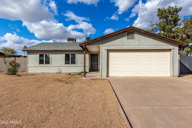 ranch-style house featuring concrete driveway, roof with shingles, an attached garage, fence, and stucco siding