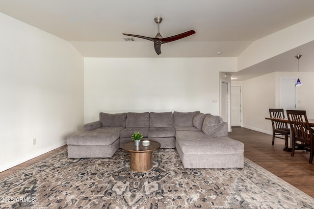 living room with baseboards, visible vents, lofted ceiling, ceiling fan, and wood finished floors