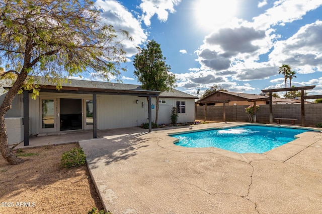 view of swimming pool featuring a patio area, a fenced backyard, and a fenced in pool