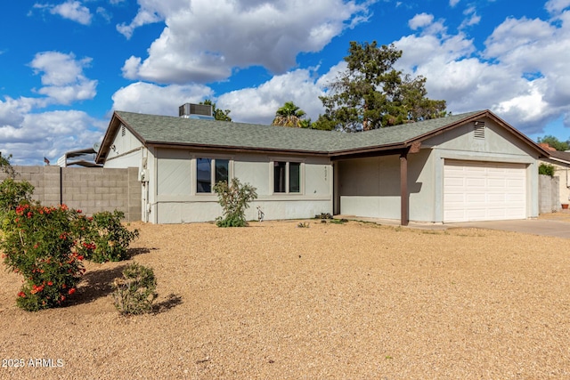 view of front of property featuring stucco siding, a shingled roof, an attached garage, fence, and driveway