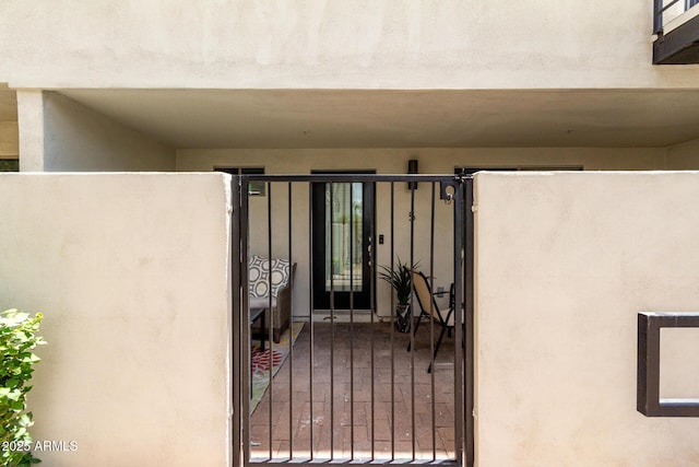3635 N 68th St Unit 5, Scottsdale, AZ 85251 - view of exterior entry with a gate and stucco siding