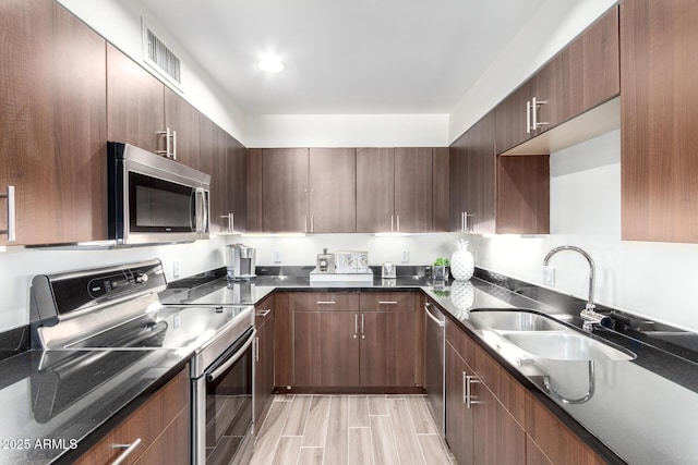 3635 N 68th St Unit 5, Scottsdale, AZ 85251 - kitchen with stainless steel appliances, a sink, and modern cabinets