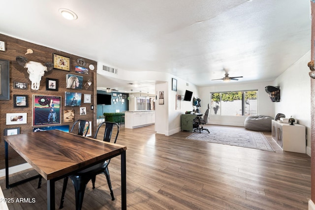 dining area with ceiling fan and hardwood / wood-style floors