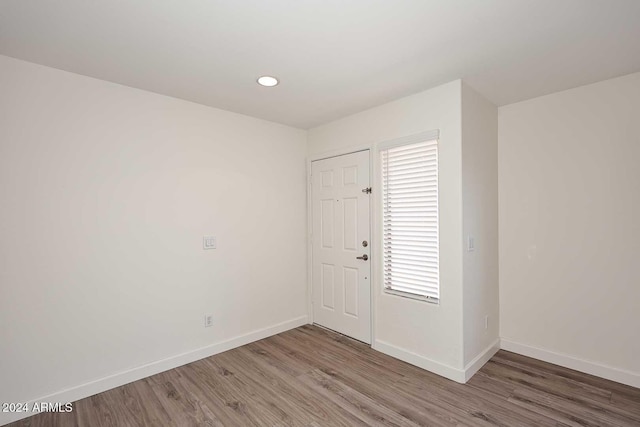 entrance foyer featuring recessed lighting, wood finished floors, and baseboards