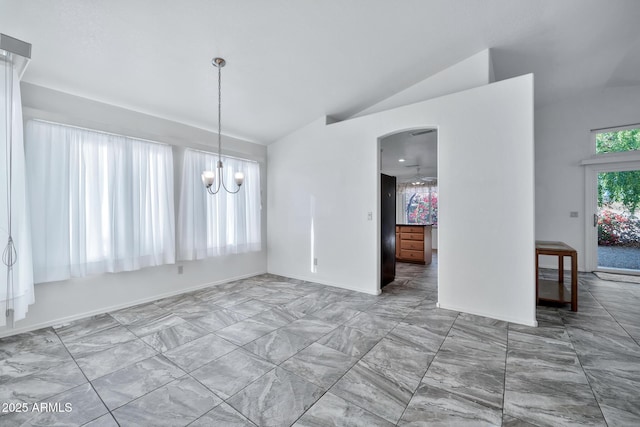 unfurnished dining area featuring lofted ceiling and an inviting chandelier