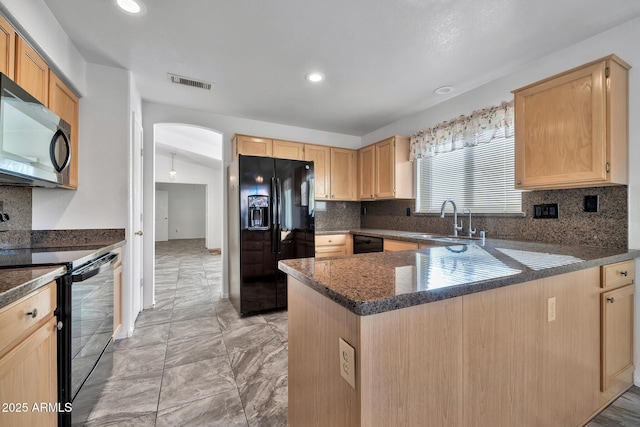 kitchen featuring sink, decorative backsplash, light brown cabinetry, and black appliances