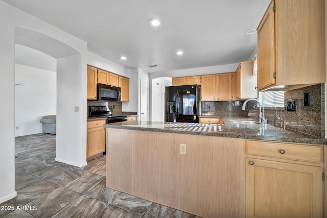 kitchen featuring black appliances, kitchen peninsula, light brown cabinetry, and sink