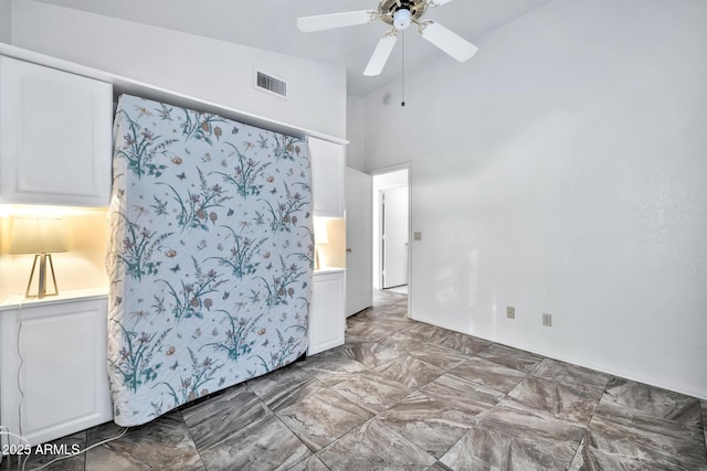 unfurnished bedroom featuring high vaulted ceiling and ceiling fan