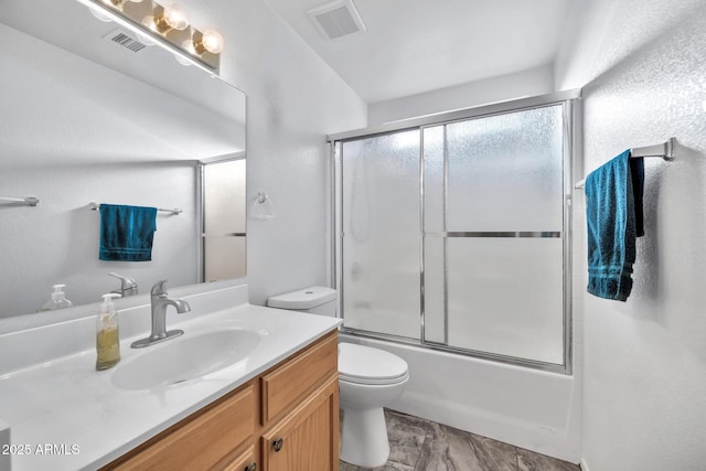 full bathroom featuring bath / shower combo with glass door, vanity, and toilet