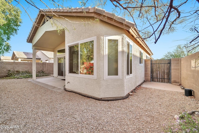 view of side of property featuring a patio