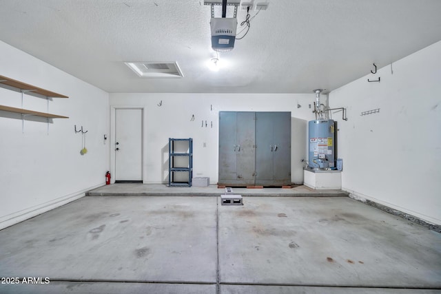 garage featuring a garage door opener and gas water heater