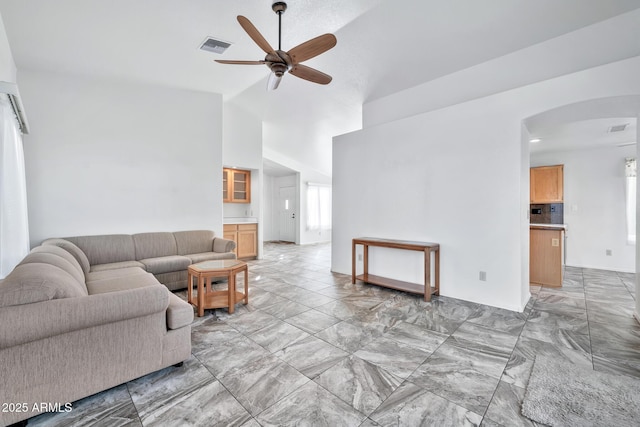 living room featuring ceiling fan and vaulted ceiling