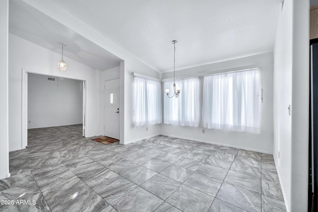 unfurnished dining area featuring lofted ceiling and a chandelier