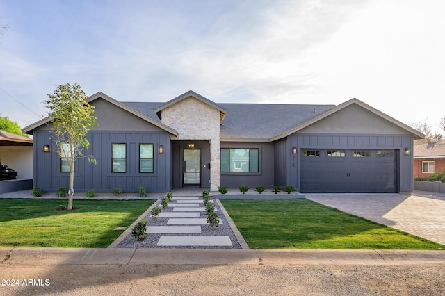 view of front of property with a front lawn and a garage