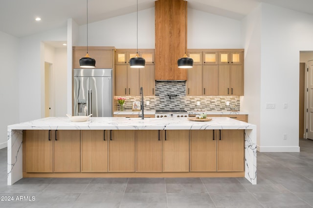 kitchen with pendant lighting, a large island, and stainless steel built in fridge