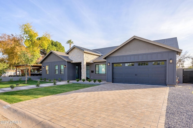 view of front of property with a garage and a front lawn