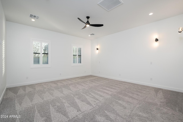 empty room with light colored carpet and ceiling fan