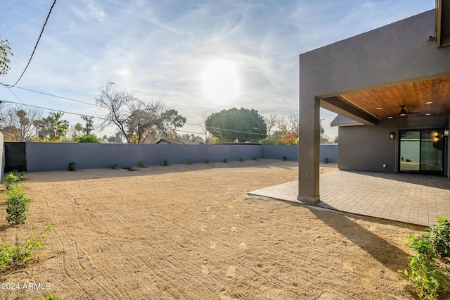 view of yard featuring a patio area and ceiling fan