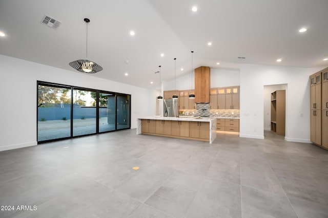 kitchen with backsplash, high vaulted ceiling, hanging light fixtures, a large island, and stainless steel fridge with ice dispenser