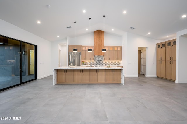 kitchen featuring pendant lighting, backsplash, high vaulted ceiling, a large island with sink, and stainless steel built in fridge