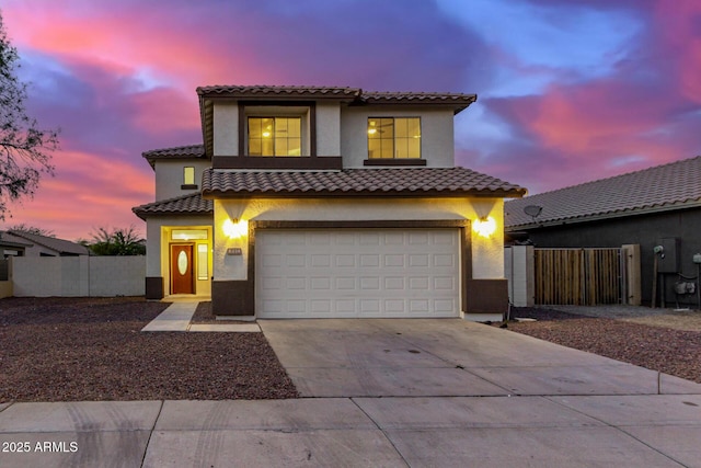 mediterranean / spanish-style house with a garage