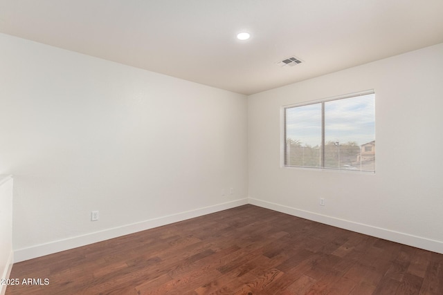 spare room with dark hardwood / wood-style flooring