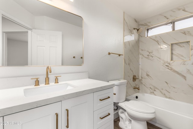 full bathroom featuring vanity, toilet, and tiled shower / bath