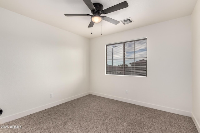 empty room featuring carpet floors and ceiling fan