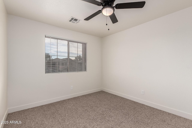 spare room featuring ceiling fan and carpet