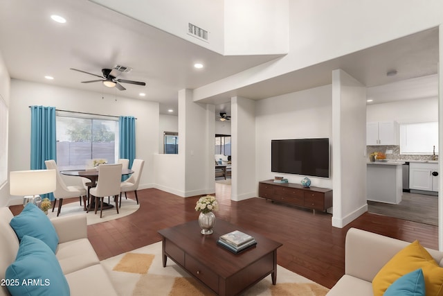 living room featuring ceiling fan and light wood-type flooring