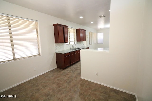 kitchen featuring tasteful backsplash, sink, and tile patterned floors