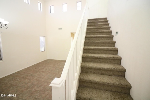 stairway with a towering ceiling