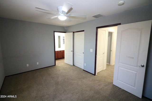 unfurnished bedroom featuring ceiling fan and light carpet