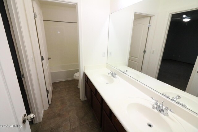 bathroom with vanity, tile patterned floors, and toilet