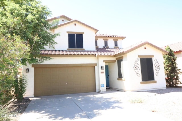 mediterranean / spanish-style house with a garage